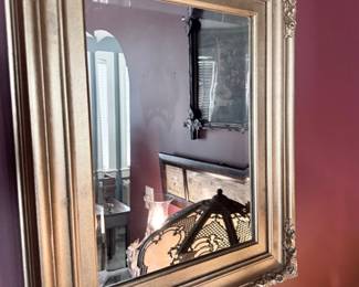 Large gold gilt-framed beveled wall mirror