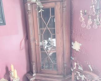 Antique carved corner china cabinet with crystal sconce