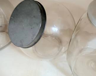 Antique glass counter jars with zinc lids, pair