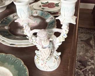 Porcelain figural candelabra with applied flowers and cherub