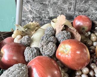 Decorative fall fruit and pinecone centerpiece arrangement