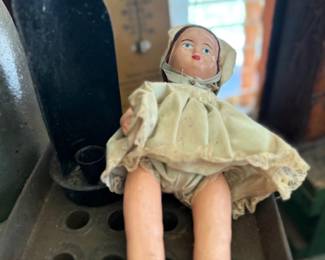 Antique composition doll in cream dress