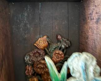 Cast iron flower doorstops in cabinet