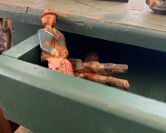 Folk art carved figure in primitive green cabinet