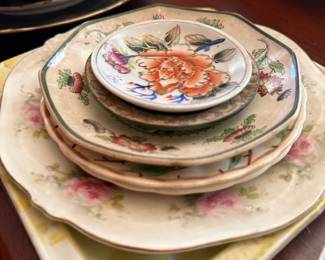 Stacked antique floral china plates, mixed makers