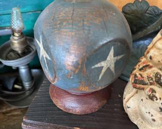 Folk art painted globe with stars on stand