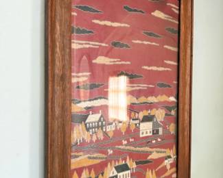 Folk art embroidered village scene, framed