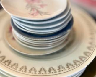 Stack of antique china plates, mixed patterns