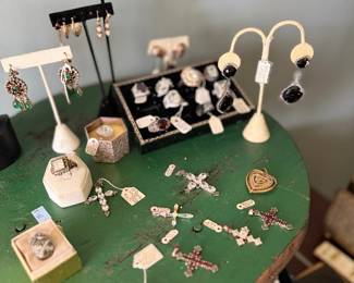 Antique cross pendants, rosaries, and earring display