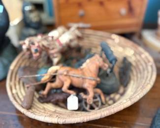 Antique toy horses in coiled basket tray