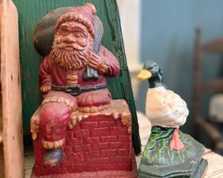 Antique cast iron Santa and duck doorstops