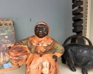 Vintage folk art pottery figure and cast iron pig