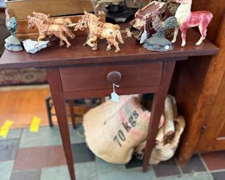 Antique side table with toy animals and candelabra