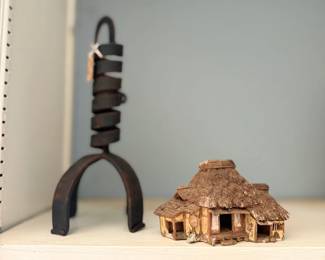 Wrought iron twist stand and miniature thatched cottage