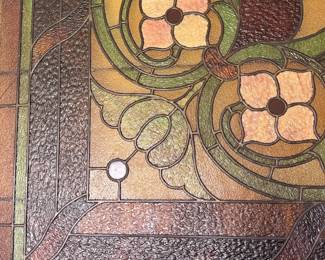 Stained glass window close-up, floral Arts and Crafts design