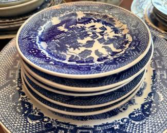 Stack of blue willow plates, various sizes