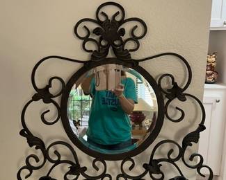 Iron wall mirror intricate scrollwork itnegrated dual candelabra sconces