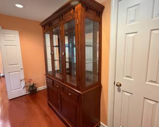F1 - $250. Lighted China Cabinet. Moves in 2 pieces. Measures 56“ x 18.5” x 81” tall.