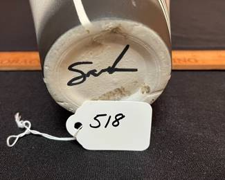 A518 - $35. Signed Sarah? Tall Black, White, Gray pottery vase. Measures 6" x 13" tall. 