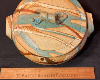A497 - $30. Brown and Teal Lidded Casserole Dish - Signed - Illegible.  Measures 10" x 5" tall. 