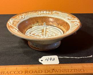 A492 - $25. Brown and Blue Footed Bowl With Handles. Unsigned. Measures 8.5" x 3" tall. 