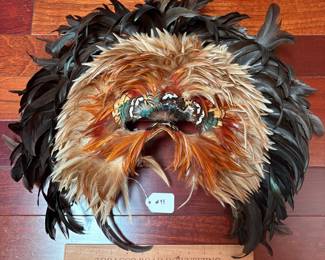 A99 - $100. Gwen Bennett : Feather Mask. Measures 21" x 18" tall. 