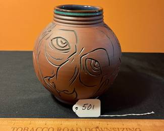 A501 - $65. Terra Cotta Vessel With Faces - Stamped . Measures 6" x 8" tall.