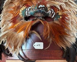 A99 - $100. Gwen Bennett : Feather Mask. Measures 21" x 18" tall. 