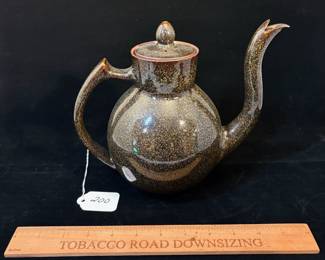 A200 - $75. Takashi Ichihara: "Wave" Teapot With Golden Brown Glaze. Measures 9" x 7.25" tall. 