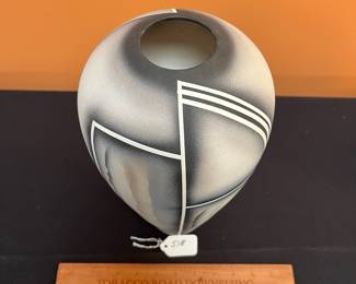 A518 - $35. Signed Sarah? Tall Black, White, Gray pottery vase. Measures 6" x 13" tall. 