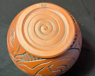 A501 - $65. Terra Cotta Vessel With Faces - Stamped . Measures 6" x 8" tall.