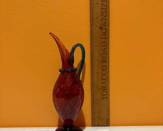 A467 - $65. Red swirl Glass Pitcher - signed Nunwell 1995.  Measures 4" x 5" tall. 