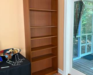 F6 - $40. Single Wooden Bookcase. Adjustable shelves. Measures 31.75” x 11” x 79.5” tall.