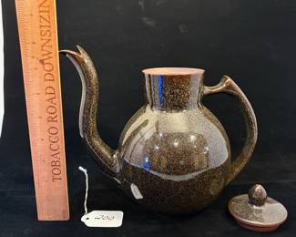 A200 - $75. Takashi Ichihara: "Wave" Teapot With Golden Brown Glaze. Measures 9" x 7.25" tall. 