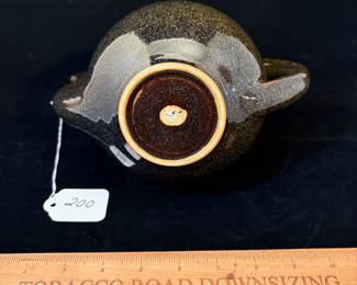A200 - $75. Takashi Ichihara: "Wave" Teapot With Golden Brown Glaze. Measures 9" x 7.25" tall. 