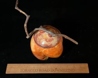 A503 - $125. Orange and Black Lidded Jar with Stick Top. Measures 7.5" x 9.75" tall. 