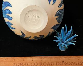 A502 - $100. Natalie Blake. Clay Vase with Blue Floral Flower Top. Measures 8" x 12.25" tall. Some flower tips have been repaired.