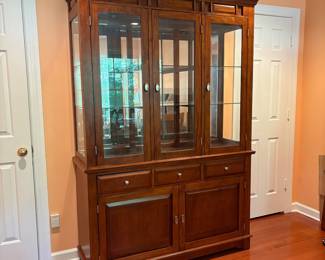 F1 - $250. Lighted China Cabinet. Moves in 2 pieces. Measures 56“ x 18.5” x 81” tall.