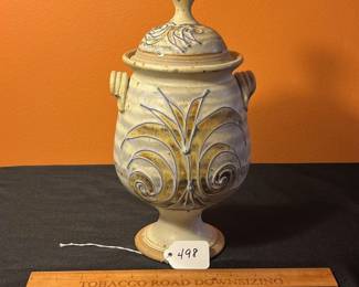 A498 - $30. Brown and Blue Floral Footed Lidded Canister Jar Urn. Signed Don. Measures 5.5" x 11.75" tall. 