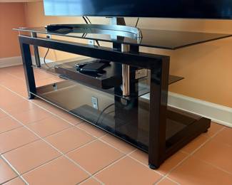 F4 - $50. Glass & Metal Media Stand. Measures 52” x 19.75” x 20.25” tall.