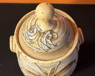 A498 - $30. Brown and Blue Floral Footed Lidded Canister Jar Urn. Signed Don. Measures 5.5" x 11.75" tall. 