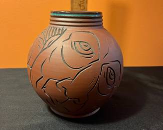 A501 - $65. Terra Cotta Vessel With Faces - Stamped . Measures 6" x 8" tall.