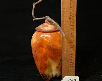 A503 - $125. Orange and Black Lidded Jar with Stick Top. Measures 7.5" x 9.75" tall. 