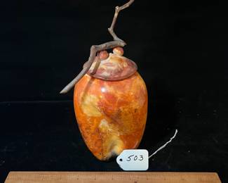A503 - $125. Orange and Black Lidded Jar with Stick Top. Measures 7.5" x 9.75" tall. 