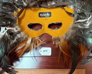 A99 - $100. Gwen Bennett : Feather Mask. Measures 21" x 18" tall. 