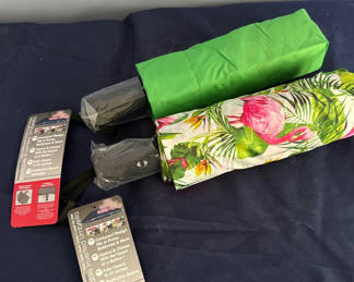 Lot 31: Two compact inverted umbrellas with protective sleeves
