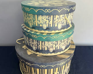 Lot 17: Stack of decorative round hat boxes with teal and gold patterns