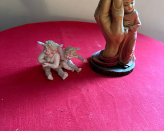 Lot 136: Religious figurine group: hand sculpture cradling a baby and a Tiffany cherub