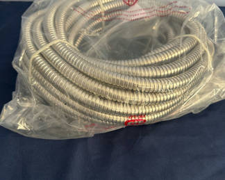 Lot 4: Coiled flexible metal hose and garden hands