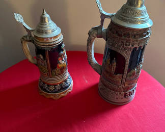 Lot 138: Two decorative beer steins with pewter lids